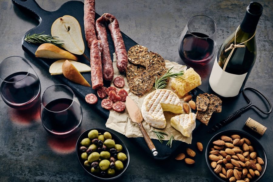 Charcuterie-board-with-bottles-and-glasses-filled-with-wine.-